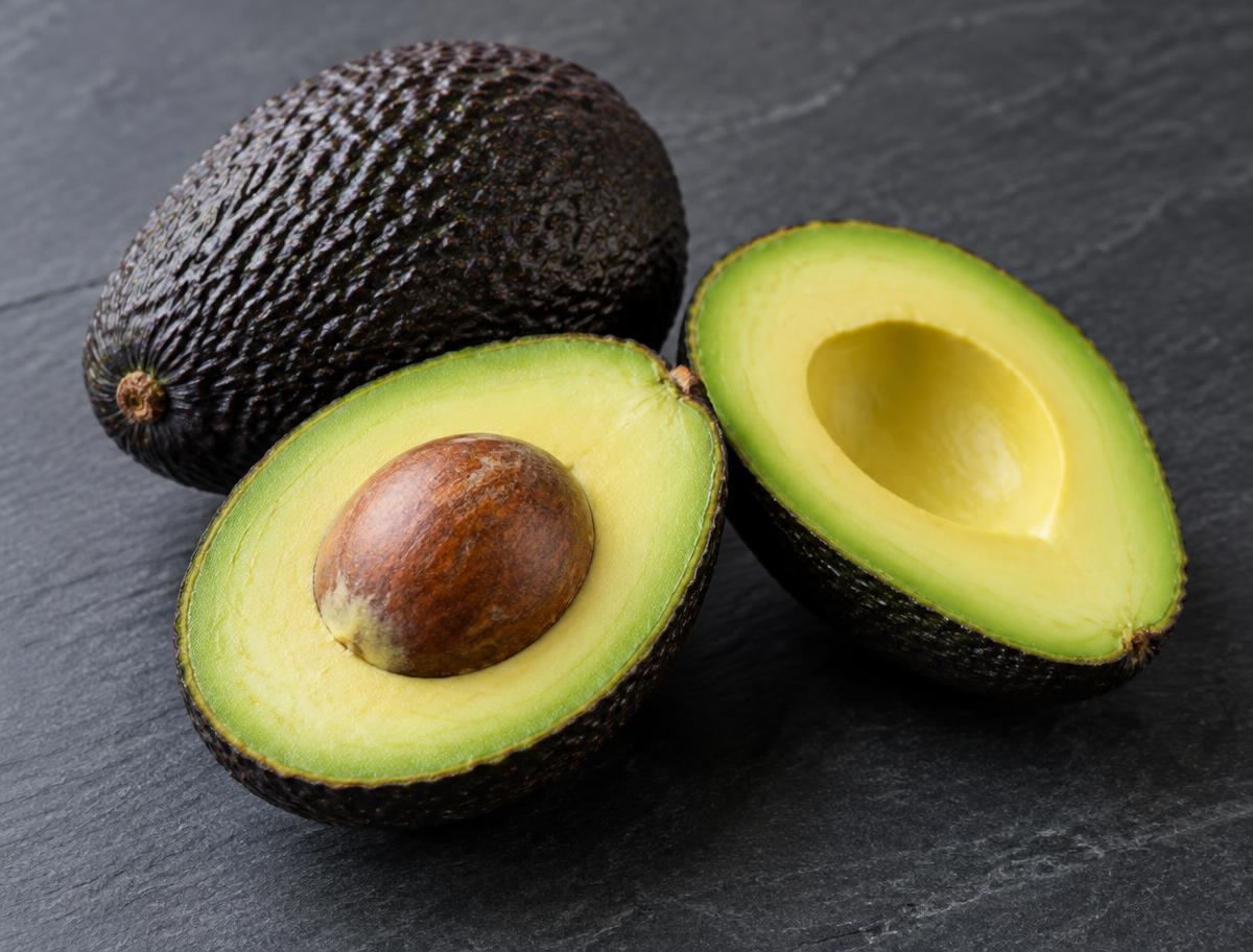 Hass avocado whole and cut in half